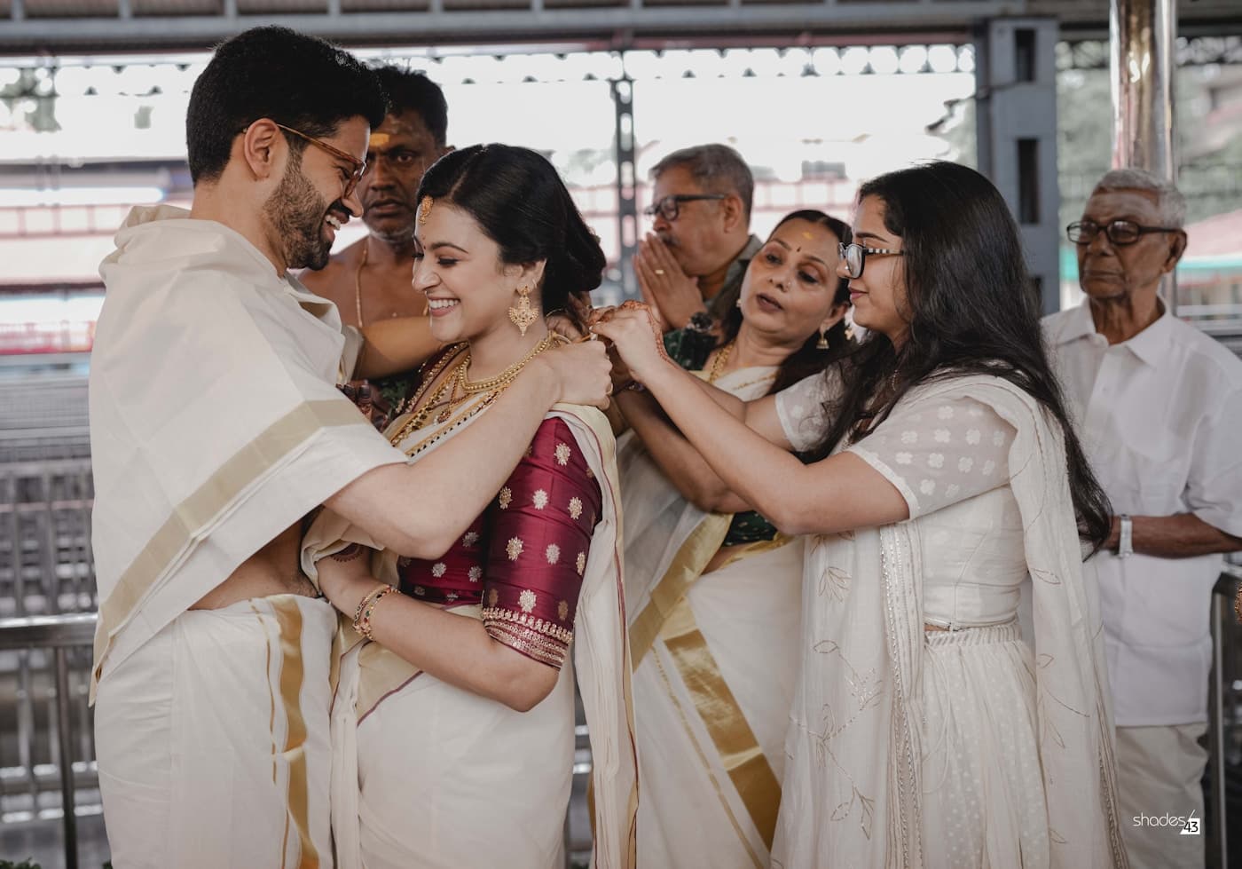 South Asian wedding couple in traditional dress during a ceremonial blessing